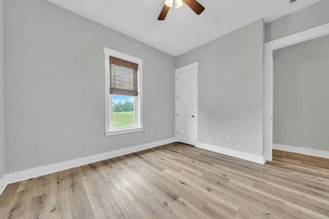 spare room with light hardwood / wood-style floors and ceiling fan