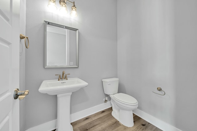 bathroom with sink, wood-type flooring, and toilet