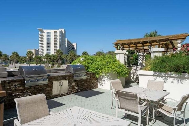 view of patio / terrace featuring an outdoor kitchen and a grill