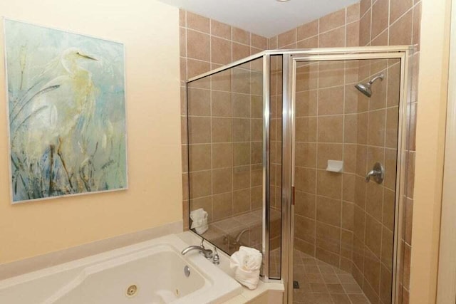 bathroom featuring separate shower and tub