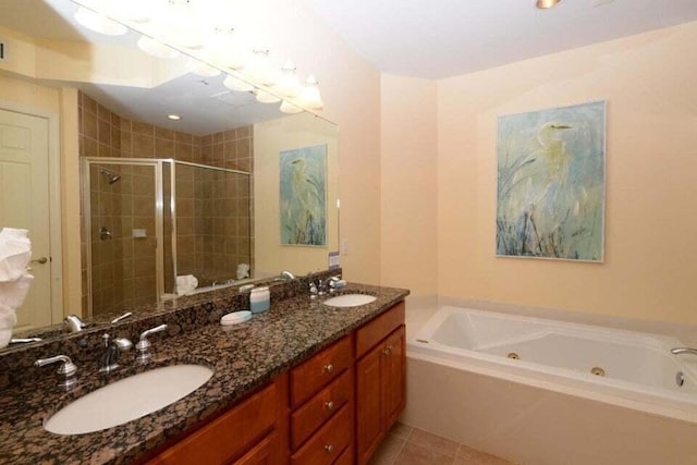 bathroom featuring plus walk in shower, tile patterned flooring, and vanity