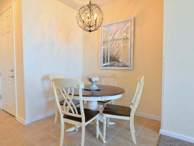 dining area featuring a chandelier and tile patterned flooring