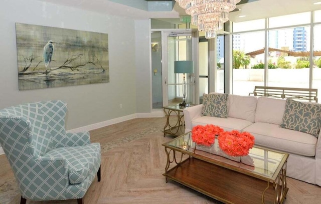 living room featuring light parquet flooring, a wealth of natural light, and a chandelier