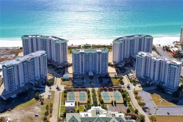 bird's eye view with a water view and a beach view