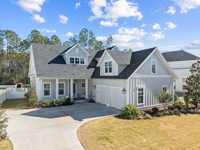 view of front of house featuring a front lawn, a garage, and a porch