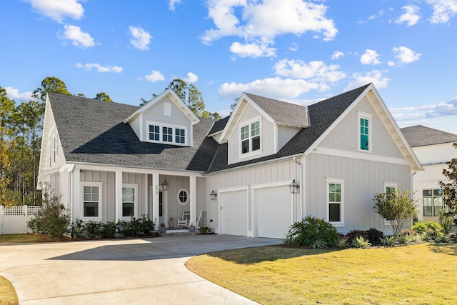 view of front of property with a front yard and a garage