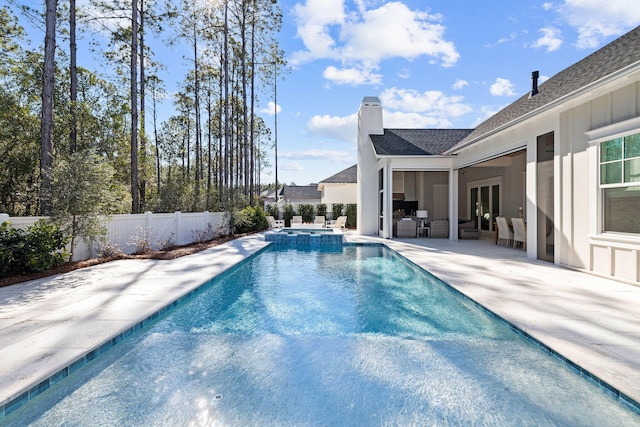 view of pool with a patio and an in ground hot tub