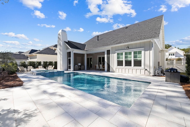 view of pool featuring an in ground hot tub and a patio