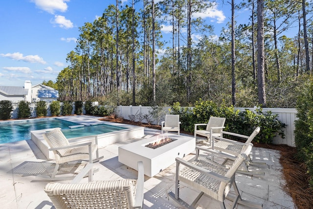 view of pool with a patio area and a fire pit