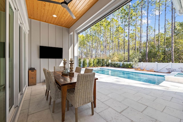 view of swimming pool with ceiling fan and a patio