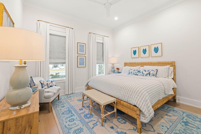 bedroom featuring ceiling fan, ornamental molding, and hardwood / wood-style floors