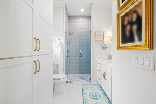 bathroom with a shower with shower door, vanity, tile patterned flooring, and toilet