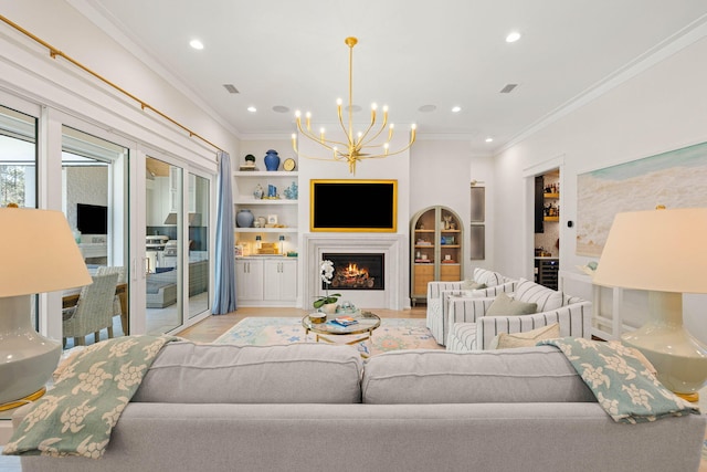 living room featuring light hardwood / wood-style floors, built in features, and crown molding