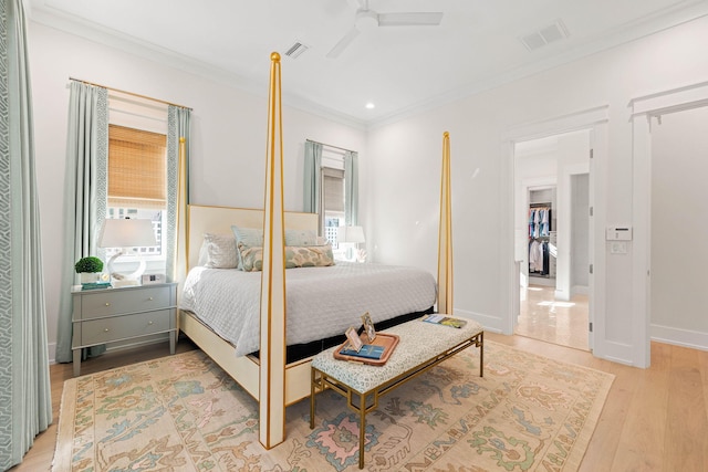 bedroom with ceiling fan, light hardwood / wood-style flooring, and ornamental molding