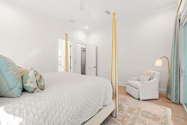 bedroom featuring crown molding and light hardwood / wood-style flooring