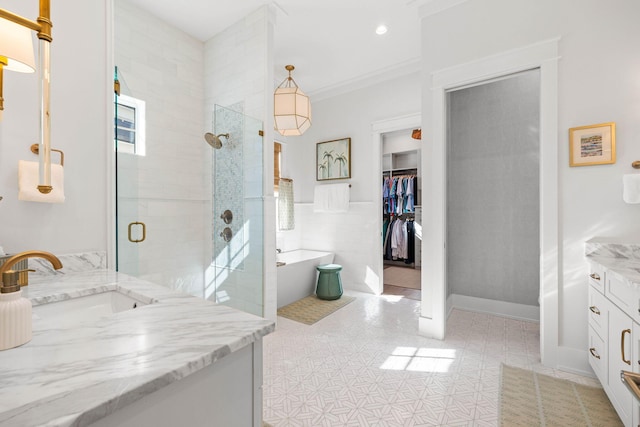 bathroom with shower with separate bathtub, tile walls, tile patterned floors, and vanity