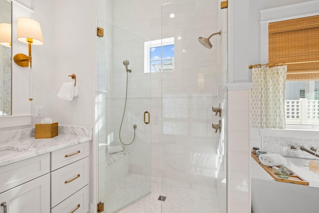 bathroom featuring walk in shower and vanity