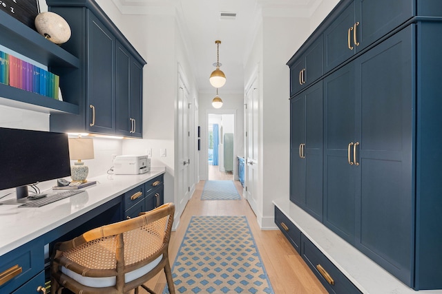 interior space with blue cabinetry and pendant lighting