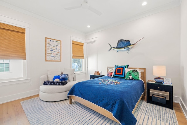 bedroom featuring ceiling fan, hardwood / wood-style floors, and crown molding