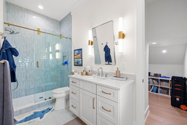 bathroom featuring toilet, vanity, a shower with door, and hardwood / wood-style floors