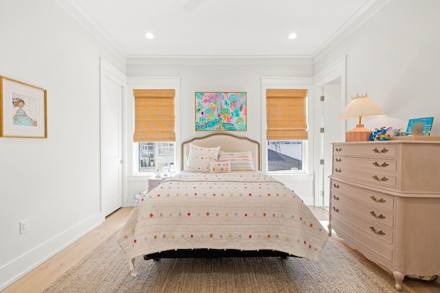 bedroom featuring ceiling fan, ornamental molding, and light hardwood / wood-style floors