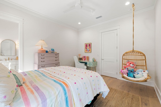 bedroom with ceiling fan, crown molding, and hardwood / wood-style floors