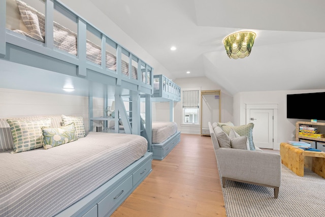 bedroom with light hardwood / wood-style flooring and lofted ceiling