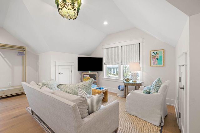 living room with light hardwood / wood-style flooring and lofted ceiling