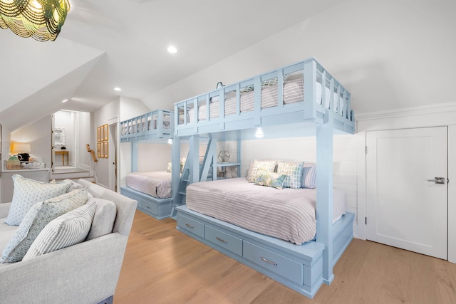 bedroom with lofted ceiling and light hardwood / wood-style floors