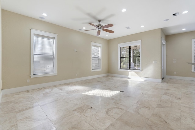 empty room featuring ceiling fan and a healthy amount of sunlight