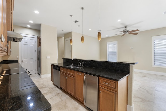 kitchen with decorative light fixtures, dark stone countertops, sink, refrigerator, and stainless steel dishwasher