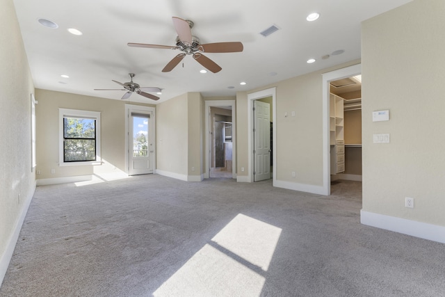 unfurnished living room featuring ceiling fan and light colored carpet