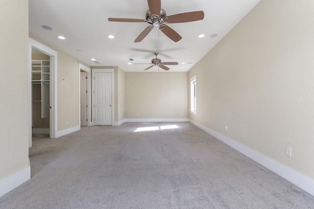 carpeted spare room with ceiling fan