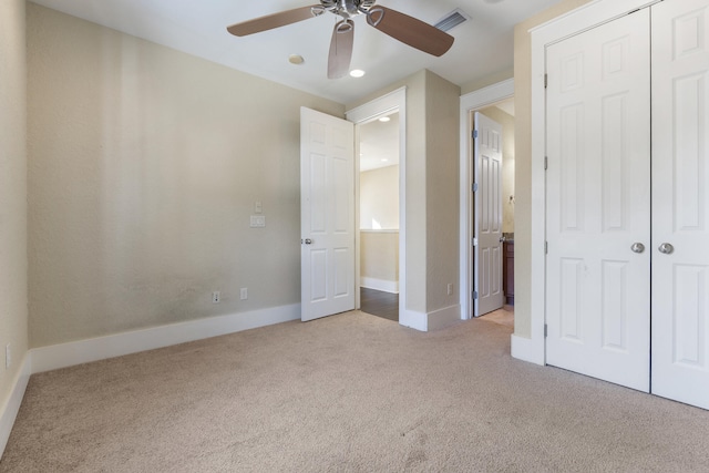 unfurnished bedroom featuring ceiling fan, light colored carpet, and a closet