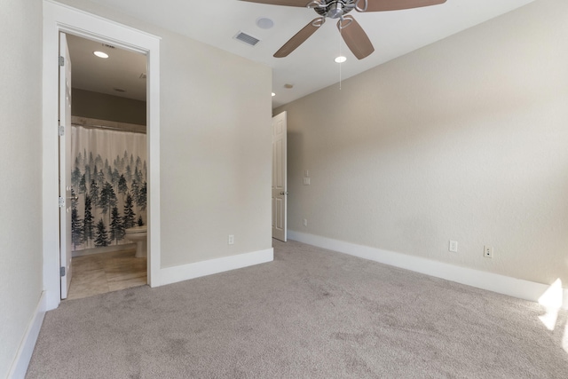 carpeted spare room featuring ceiling fan