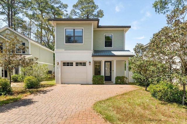 31 Beacon Point Dr, Santa Rosa Beach, FL 32459 - view of front of home with decorative driveway, an attached garage, a metal roof, and a porch