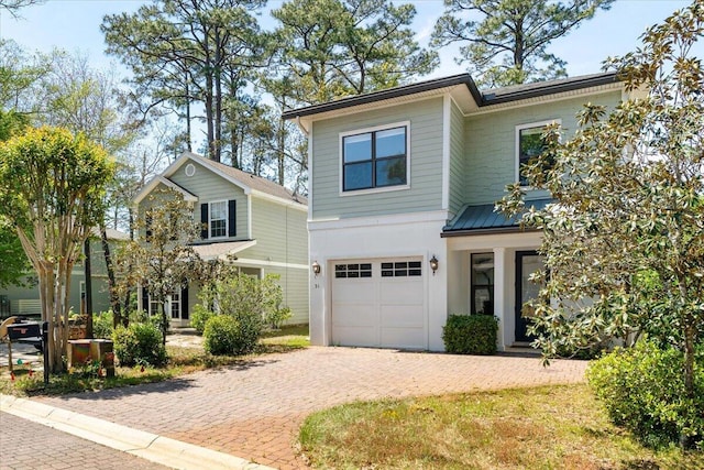 31 Beacon Point Dr, Santa Rosa Beach, FL 32459 - view of front of property featuring a garage, decorative driveway, and a metal roof