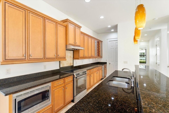 31 Beacon Point Dr, Santa Rosa Beach, FL 32459 - kitchen featuring appliances with stainless steel finishes, under cabinet range hood, pendant lighting, dark stone counters, and recessed lighting