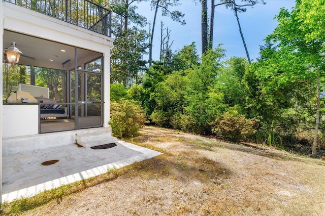 31 Beacon Point Dr, Santa Rosa Beach, FL 32459 - view of yard featuring a sunroom, entry steps, a patio area, and a balcony