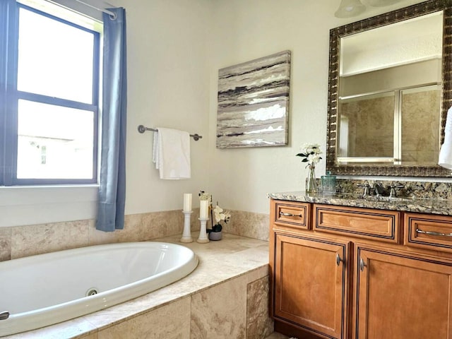 31 Beacon Point Dr, Santa Rosa Beach, FL 32459 - full bathroom featuring a whirlpool tub, vanity, and a tile shower