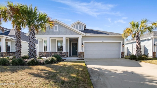 craftsman-style house with a front lawn and a garage