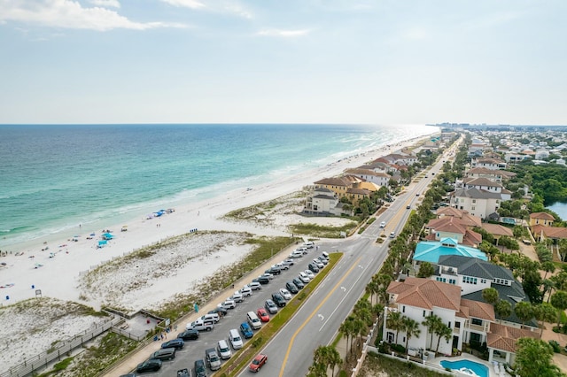 drone / aerial view featuring a water view and a beach view