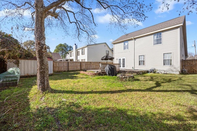 rear view of property featuring a lawn