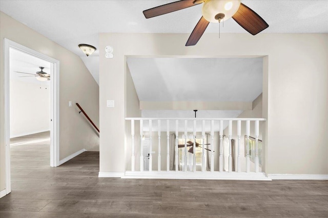 stairway featuring ceiling fan and wood-type flooring