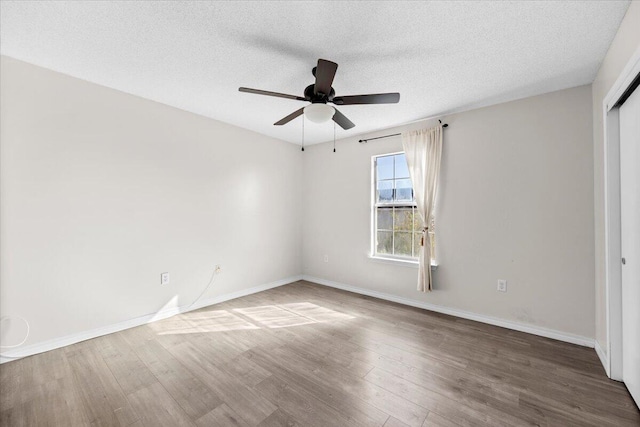 unfurnished room featuring ceiling fan, a textured ceiling, and hardwood / wood-style floors