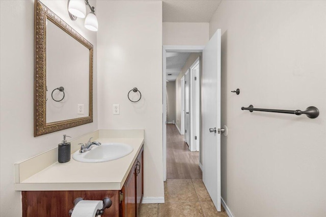 bathroom with vanity, tile patterned floors, and a textured ceiling