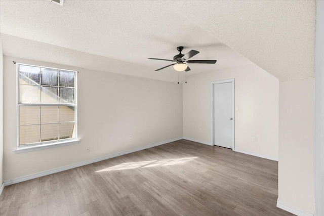 interior space with hardwood / wood-style flooring, a textured ceiling, and ceiling fan