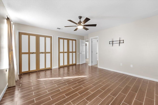 spare room with ceiling fan and dark hardwood / wood-style flooring