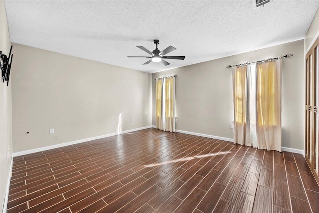 spare room with a textured ceiling and ceiling fan