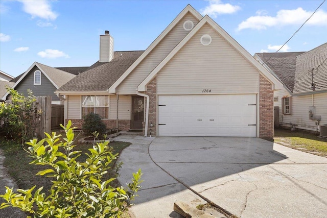 view of front of house featuring a garage and central AC